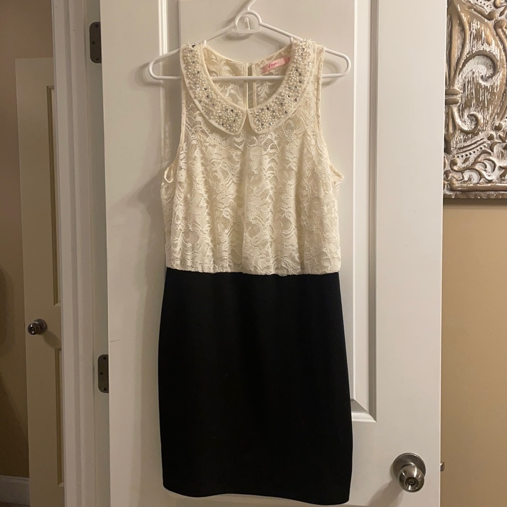 Black and cream dress. Lace on top. Pencil fit on bottom.